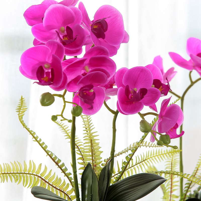 Orquídea artificial en maciza en maceta roja vendida con alta calidad