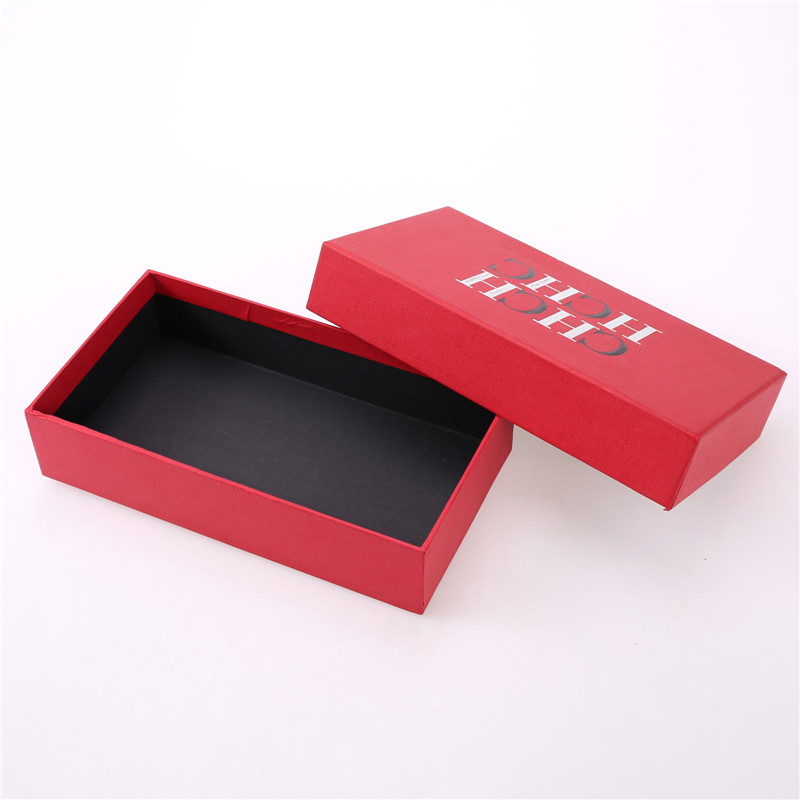 Caja de papel rojo con tapa.