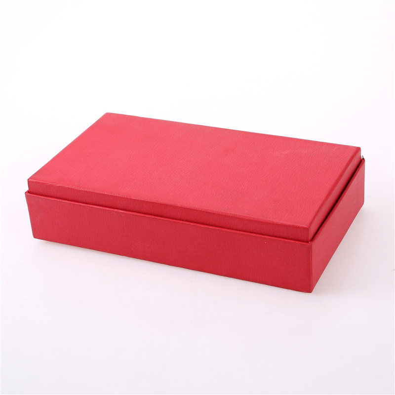 Caja de papel rojo con tapa.